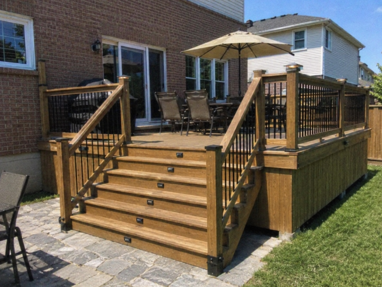 Multi-step wood deck with umbrella and dining set